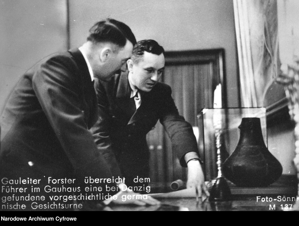 Gauleiter Albert Forster presents Adolf Hitler a prehistorical urn discovered near Danzig, Poland